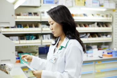 Female pharmacist looking at product
